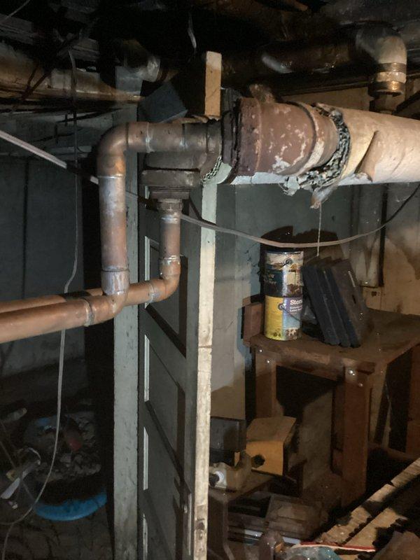 Conducted comprehensive on-site assessment of existing boiler system and associated mechanical infrastructure in basement utility area. Documented current conditions of HVAC ductwork, copper piping network, insulated supply lines, and mechanical equipment including circulator pump assembly. Evaluated metal ductwork system with insulated cylindrical sections, rectangular plenum connections, and support framework. Inspected copper pipe routing, flexible conduit installations, and protective coverings on insulated piping. Photographed all relevant components to support estimate preparation for boiler replacement or upgrade project.