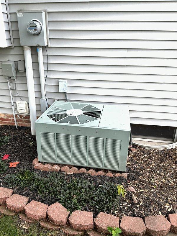 Responded to emergency no cooling call for 24-year-old residential air conditioning system. Upon arrival, performed diagnostic evaluation of the outdoor condensing unit and assessed overall system condition given the age of the equipment. Documented the existing HVAC installation with the condensing unit positioned on concrete pad against exterior wall with proper electrical service connection via meter and disconnect switch. Given the advanced age of the unit at 24 years—well beyond typical equipment lifespan of 15-20 years—discussed system condition and replacement options with homeowner, as repairs on equipment of this vintage often prove cost-prohibitive and parts availability becomes increasingly limited.