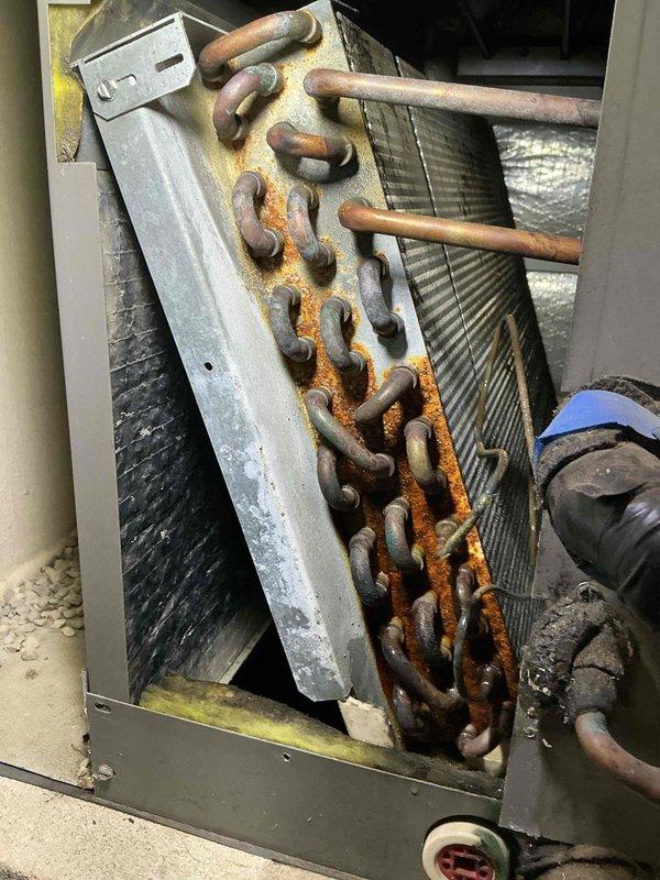 Completed tune-up service on a 2-year-old mini-split system consisting of one outdoor condensing unit and one indoor air handler. Performed standard maintenance procedures including inspection of refrigerant lines, electrical connections, and drainage system. Documented existing condition of equipment, noting significant rust and corrosion present on the mounting chain and hardware securing the indoor unit, which may require future attention to prevent potential equipment stability issues.