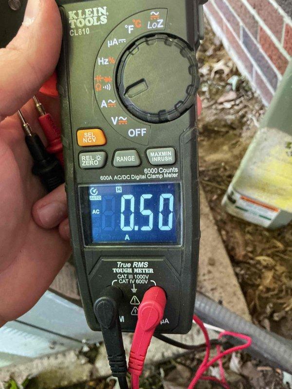 # HVAC Service Completed

Responded to service call for 16-year-old air conditioning system with reduced airflow and insufficient cooling throughout home. Customer reported drain functioning properly and filter recently replaced.

Upon arrival, performed comprehensive system diagnostics. Accessed electrical panel to inspect power supply and circuit protection for outdoor condensing unit. Panel inspection revealed significant accumulation of dust, debris, and cobwebs indicating lack of recent maintenance, though all circuit breakers were functioning properly and connections were secure.

Proceeded to outdoor unit for electrical testing. Using digital clamp meter, measured amperage draw on compressor circuit, which registered 0.50 amps—significantly below normal operating range for a residential AC compressor. This abnormally low amperage reading indicated compressor failure or loss of refrigerant charge preventing compressor from running under load.

Given the age of the system at 16 ye