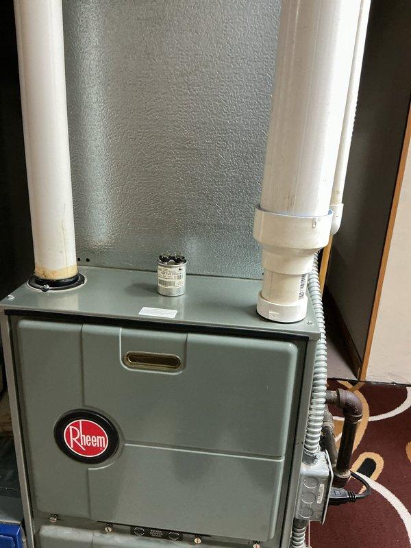 Completed routine maintenance on 16-year-old residential air conditioning system with Rheem furnace. Customer reported intermittent humming noise that had ceased prior to service visit and indicated extended period since last maintenance. Performed standard tune-up procedures including inspection of furnace unit, capacitor functionality verification, refrigerant line assessment, and PVC venting system check. All components found operational with capacitor marked in satisfactory condition.