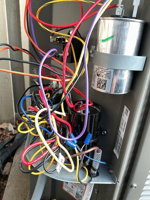 Responded to callback following recent installation regarding excessive power draw and electrical surges during AC startup. Inspected electrical components and capacitor assembly within control panel. Verified proper capacitor installation, wiring connections, and terminal integrity. System evaluated for electrical anomalies causing reported power surge condition upon compressor cycling.