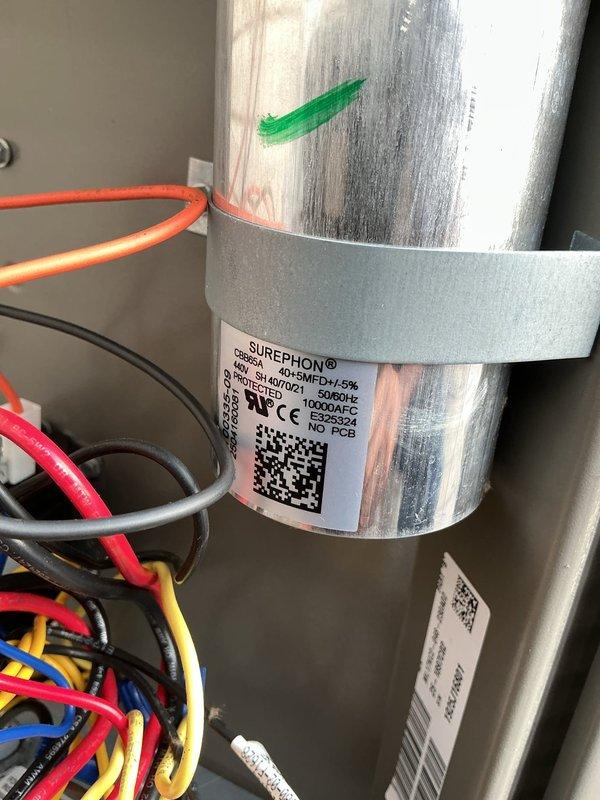 Responded to callback following recent installation regarding excessive power draw and electrical surges during AC startup. Inspected electrical components and capacitor assembly within control panel. Verified proper capacitor installation, wiring connections, and terminal integrity. System evaluated for electrical anomalies causing reported power surge condition upon compressor cycling.