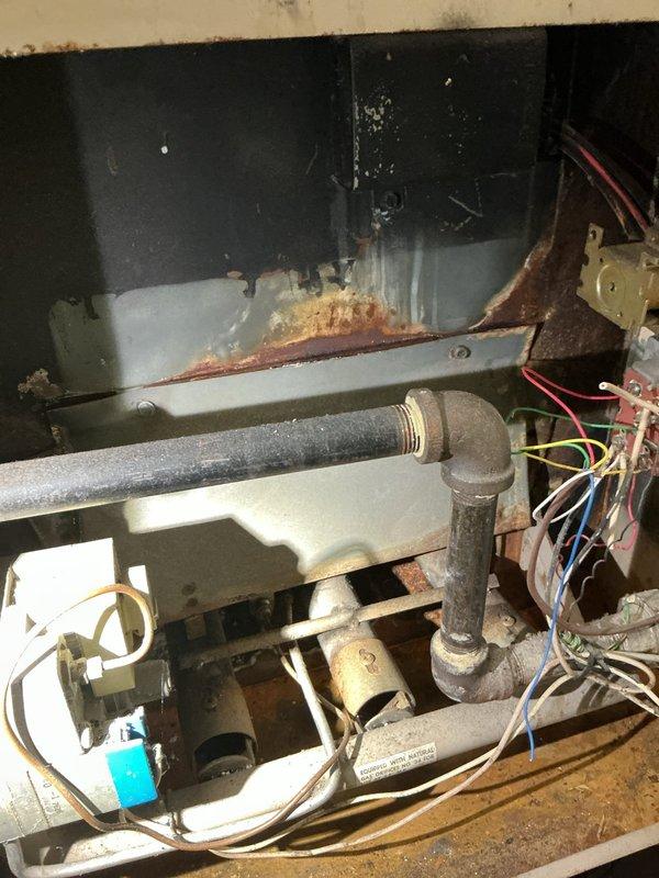 Responded to service call for 15-year-old central air conditioning system running but not cooling. Upon inspection, accessed interior components and outdoor condenser unit to diagnose cooling failure. Evaluated refrigerant levels, electrical connections, and overall system operation. Unit showed signs of age with weathered components and required clearing of overgrown vegetation around outdoor condenser for proper airflow. Assessed piping connections, motor assembly, and electrical wiring throughout system to identify cause of inadequate cooling performance.