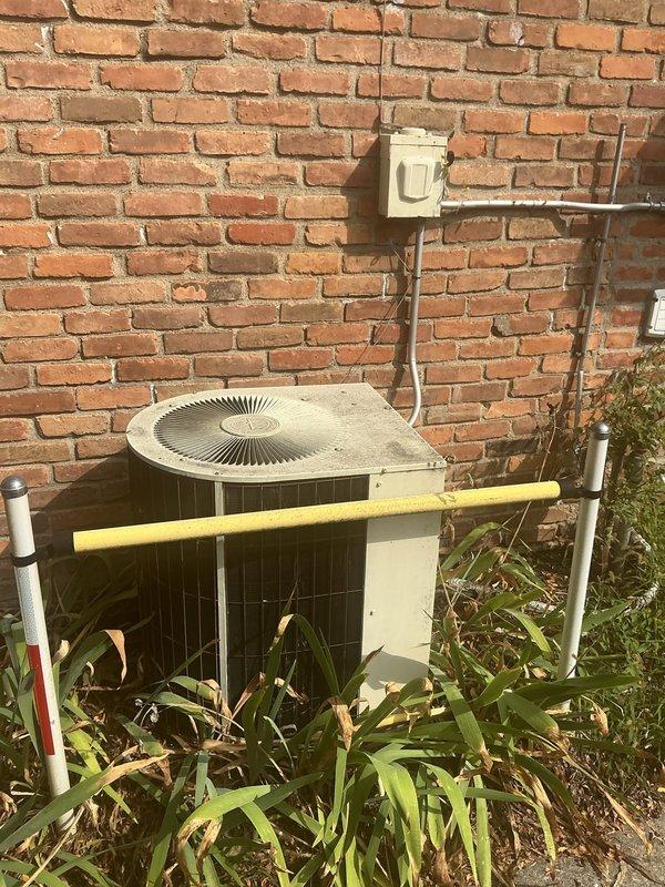 Responded to service call for 15-year-old central air conditioning system running but not cooling. Upon inspection, accessed interior components and outdoor condenser unit to diagnose cooling failure. Evaluated refrigerant levels, electrical connections, and overall system operation. Unit showed signs of age with weathered components and required clearing of overgrown vegetation around outdoor condenser for proper airflow. Assessed piping connections, motor assembly, and electrical wiring throughout system to identify cause of inadequate cooling performance.
