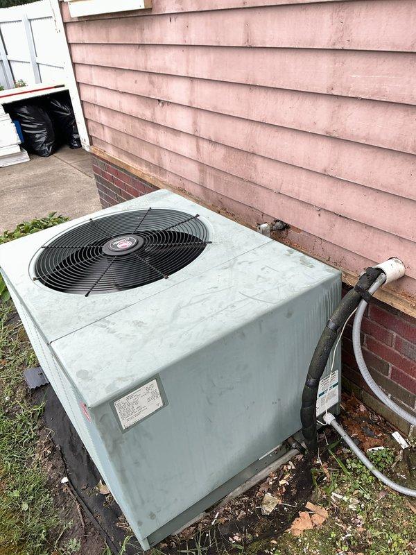 Responded to no cooling call for 20-year-old residential air conditioning system. Upon arrival, performed complete system diagnostic on outdoor condensing unit. Found unit experiencing complete failure due to age-related component degradation. Discussed system condition and available options with homeowner given the advanced age of equipment. Documented unit condition with photos showing weathered outdoor condenser with significant surface deterioration and surrounding area maintenance needs.