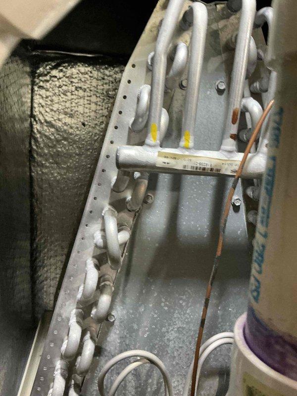Completed comprehensive air conditioning tune-up service on residential HVAC system. Performed standard maintenance inspection of evaporator coil assembly and refrigerant line connections, verified proper operation with visible condensation indicating active cooling cycle, and documented system condition with no immediate repairs required at time of service.