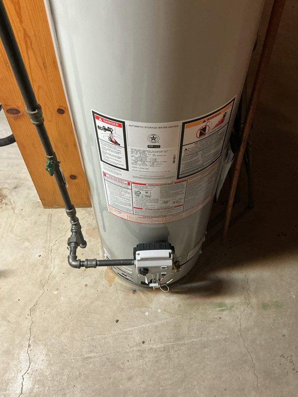 Installed a 40-gallon slim Bradford White natural gas water heater in basement utility area, replacing the existing unit. Replaced the cold water inlet shutoff valve with new components and installed fresh fittings throughout the installation per specifications, ensuring no old fittings were reused to maintain system integrity and code compliance.