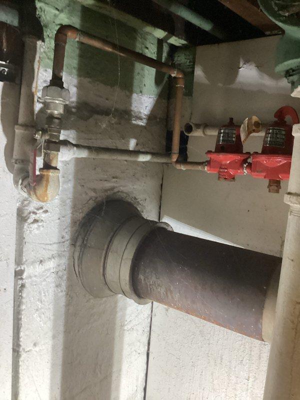 Completed comprehensive assessment of existing boiler system for replacement estimate. Inspected aging boiler unit housed in metal cabinet enclosure showing significant corrosion and wear on exterior surfaces. Evaluated gas valve assembly, burner mechanism, and associated pressure gauges within cabinet. Documented condition of existing copper supply and return piping with visible oxidation, red zone valves with pressure indicators, and horizontal ductwork passing through utility room. Photographed all mechanical components and infrastructure to provide detailed replacement specifications. Provided customer with complete estimate for new boiler installation including removal of existing equipment and integration with current piping system.