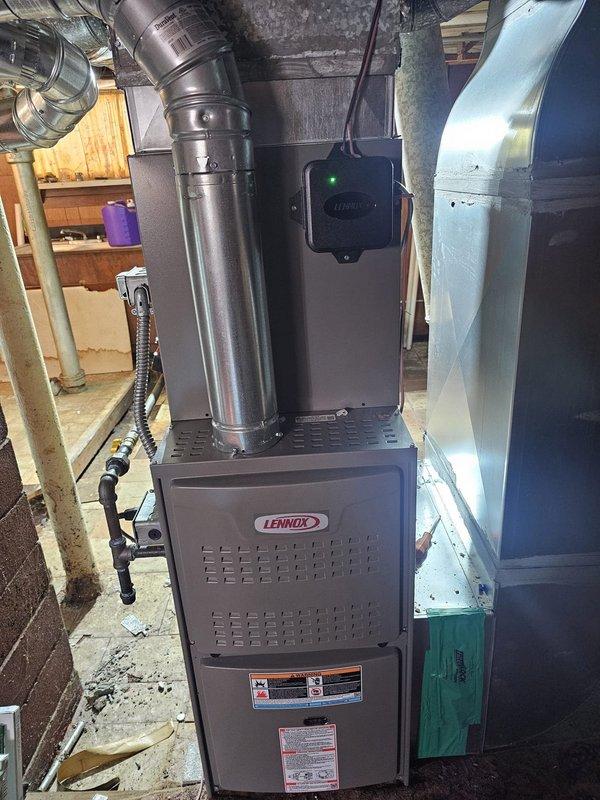 Completed full HVAC system installation including a 2-ton air conditioning condenser unit mounted on a new concrete ground pad with 30-amp disconnect box and electrical conduit properly installed per code. Installed Lennox 80% upflow furnace in basement with B cabinet configuration, paired with uncased 2-ton evaporator coil and connected with 20-foot lineset. Installed new thermostat, ran all necessary ductwork connections, and completed all electrical hookups. System tested and verified operational with proper airflow and refrigerant charge confirmed.