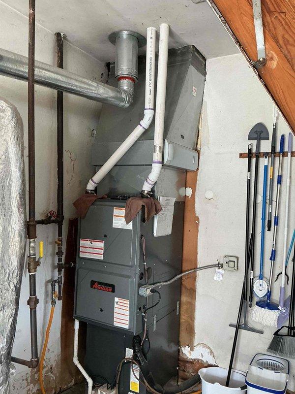 Replaced defective pressure switch and heat exchanger on Amana furnace unit. System tested and verified operational upon completion, with all safety controls functioning properly.