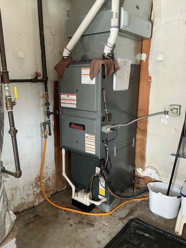 Replaced defective pressure switch and heat exchanger on Amana furnace unit. System tested and verified operational upon completion, with all safety controls functioning properly.