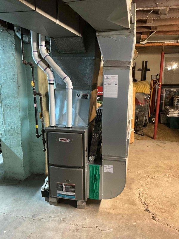 Completed comprehensive tune-up on 3-year-old Lennox gas furnace system in basement installation. Performed standard maintenance protocol including burner inspection and cleaning, heat exchanger examination, blower motor lubrication, air filter replacement, and combustion analysis to ensure proper gas-to-air ratio. Verified all safety controls, tested ignition system operation, inspected flue and PVC venting connections, and confirmed proper drainage from condensate system. Unit operating at manufacturer specifications with no deficiencies noted.