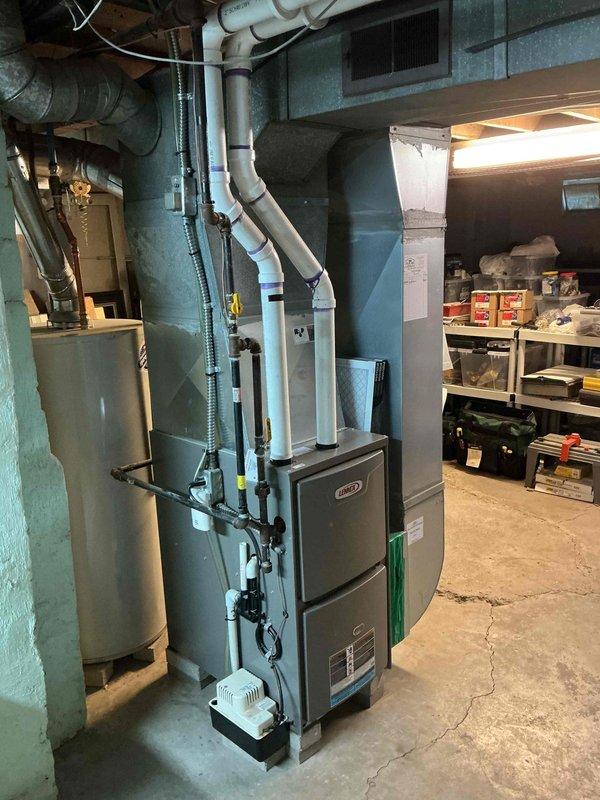 Completed comprehensive tune-up on 3-year-old Lennox gas furnace system in basement installation. Performed standard maintenance protocol including burner inspection and cleaning, heat exchanger examination, blower motor lubrication, air filter replacement, and combustion analysis to ensure proper gas-to-air ratio. Verified all safety controls, tested ignition system operation, inspected flue and PVC venting connections, and confirmed proper drainage from condensate system. Unit operating at manufacturer specifications with no deficiencies noted.