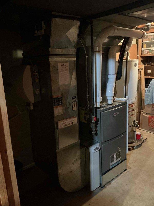Completed seasonal tune-up on 3-year-old Lennox air conditioning system with basement-installed furnace and air handler. Performed comprehensive inspection of indoor and outdoor units, verified refrigerant levels, checked electrical connections and conduit, inspected condensate drainage system and PVC piping, cleaned condenser coils, and confirmed proper airflow through ductwork. All components operating within manufacturer specifications with no deficiencies noted.