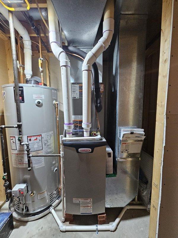 Completed full HVAC system installation in residential basement mechanical room, including 90% efficiency B cabinet upflow furnace rated at 75,000 BTU/h with Lennox branding. Installed 2.5/3 ton cased evaporator coil (B configuration) mounted to furnace plenum with proper refrigerant connections. Set 2.5 ton outdoor condensing unit on new leveled ground pad, relocating unit 3 feet from outdoor electrical meter per specifications. Ran 30'+ refrigerant line set (3/8"-3/4") with proper insulation from outdoor condenser to indoor coil, ensuring leak-free brazed connections at all joints. Installed 30 amp electrical disconnect at outdoor unit with 12' electrical insulation whip for flexible connection. Wired 240v/24v electrical junction box to provide power and control voltage to system. Installed S-40 7" smart thermostat with programming capabilities for system control. Routed white PVC condensate drain lines from furnace with proper pitch and termination. Verified all electrical connectio