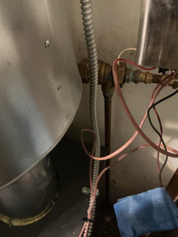Completed annual maintenance on one-year-old boiler system ahead of scheduled service date per customer request. Performed comprehensive tune-up including inspection of all electrical connections, gas valve assembly, copper piping system, and internal components. Verified proper operation of all safety controls and documented system condition with photographs showing wiring connections, brass fittings, and plumbing configuration in satisfactory working order.