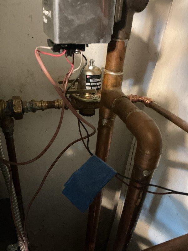 Completed annual maintenance on one-year-old boiler system ahead of scheduled service date per customer request. Performed comprehensive tune-up including inspection of all electrical connections, gas valve assembly, copper piping system, and internal components. Verified proper operation of all safety controls and documented system condition with photographs showing wiring connections, brass fittings, and plumbing configuration in satisfactory working order.