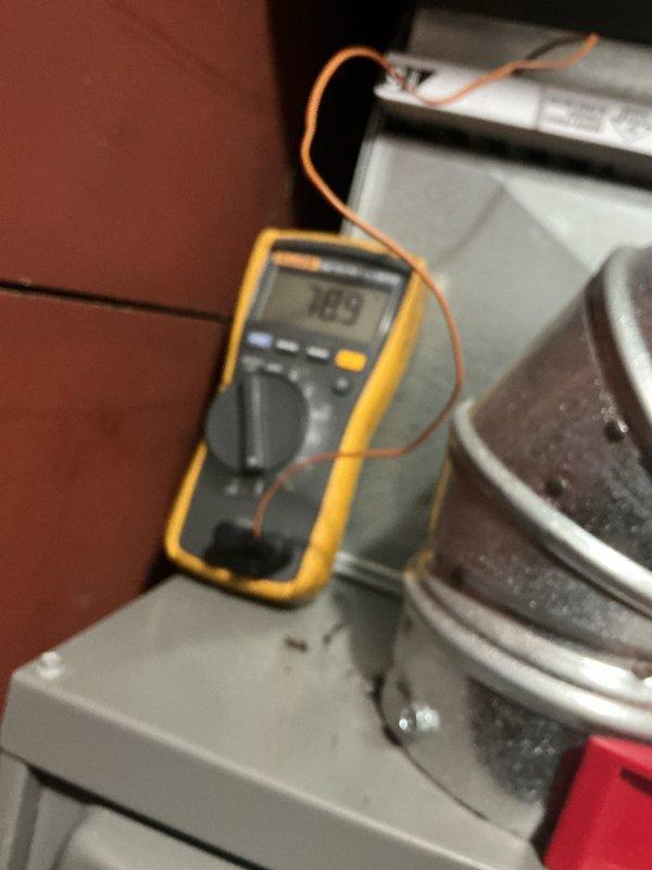 Performed comprehensive furnace maintenance on four-year-old heating system. Conducted electrical diagnostics using digital multimeter and clamp meter to verify voltage readings at 70.5V and amperage draw at 3.00A on system components. Inspected blower motor housing, air handling unit, and control board assembly. Verified all electrical connections, tested safety circuits, and confirmed proper operation of control modules. System operating within normal parameters with no issues found.