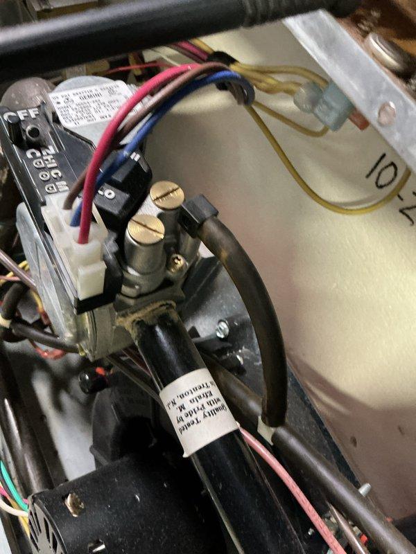 Completed comprehensive maintenance service on a 22-year-old gas-fired furnace. Performed thorough inspection of all internal components including gas valve assembly, ignition control module, burner assembly, and electrical connections. Verified proper operation of all colored wire connections (red, blue, black, and yellow) to control board and safety devices. Conducted pressure switch diagnostic testing using digital manometer, recording inlet and outlet pressure readings of 786 and 780 IWG respectively to confirm proper draft inducer motor operation and venting performance. Inspected gas valve terminals and connections for secure mounting and proper electrical continuity. Verified all safety controls, including flame sensor and limit switches, are functioning within manufacturer specifications. All components found to be operating correctly with no immediate repairs required. Unit tested and left in safe operating condition.