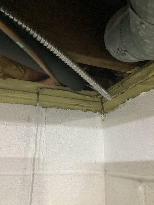 Completed comprehensive HVAC system evaluation in residential basement mechanical room for equipment replacement estimate. Assessed existing gray furnace unit with metal ductwork, water heater, and associated mechanical systems including piping, electrical connections, and ventilation components. Documented current equipment configuration, spatial layout, and infrastructure conditions including exposed ceiling joists with fiberglass insulation, utility routing through ceiling space, and concrete block wall construction to provide accurate replacement recommendations.