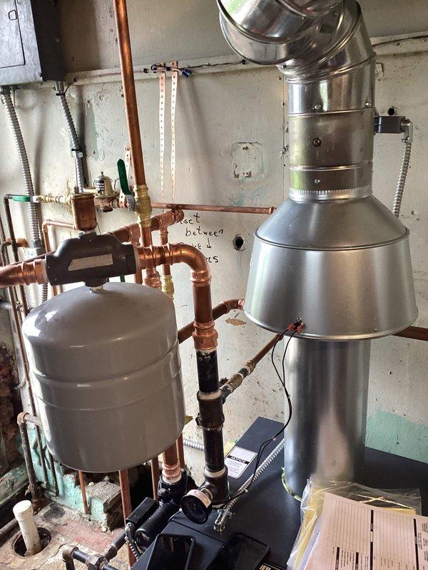 Completed full boiler system installation including conversion to LP operation with appropriate gas kit. Installed new circulator pump, expansion tank, and thermostat to support the new system. Performed complete repipe and replumb of heating lines with copper piping, installed stainless steel exhaust venting with proper penetrations through building structure, filled and pressurized the new hydronic heating system, and verified all components operational.