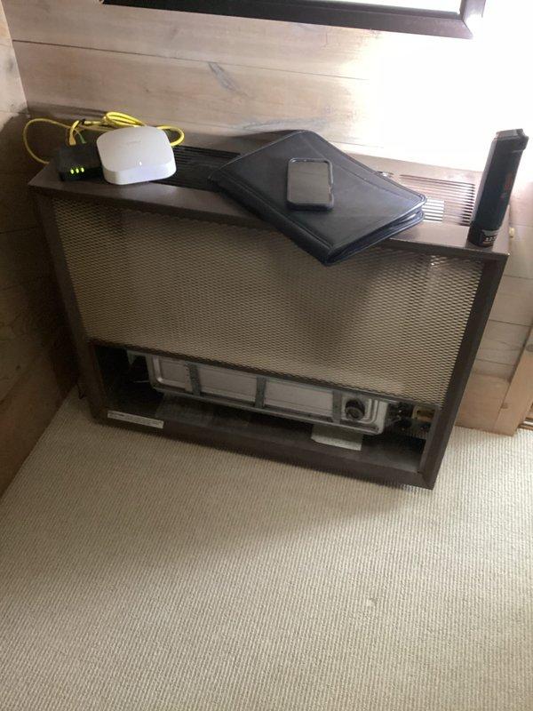 Conducted on-site evaluation for wall furnace replacement in residential property. Assessed existing HVAC unit located in upper-level space, documented current equipment configuration including filter access and control panels, and photographed exterior access point at brick wall location. Provided comprehensive estimate for complete wall furnace replacement system.