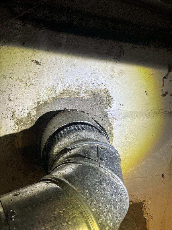 Completed inspection correction work to address code compliance and safety issues. Installed proper sleeve on masonry wall penetration for refrigerant line set, replacing inadequate caulking application. Reconnected venting to chimney liner to eliminate gap that was allowing carbon monoxide to leak into living space, restoring safe operation of heating system.