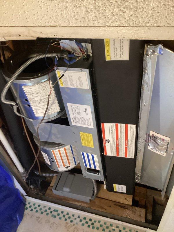 Conducted comprehensive site evaluation for complete HVAC system replacement in residential property. Assessed existing air handler unit located in attic space alongside water heater, noting current installation configuration on wooden support beams with existing electrical connections and flexible metal conduit routing. Evaluated outdoor heat pump condenser unit positioned on concrete paver pad against exterior wall with vinyl siding, including review of electrical disconnect boxes and current mounting arrangement. Documented equipment specifications, clearances, and access requirements for both indoor and outdoor components. Prepared detailed replacement estimate for new air handler and heat pump system to replace existing equipment.