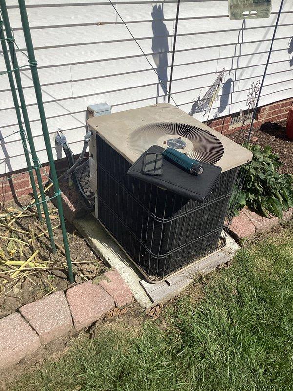 Performed comprehensive assessment of 29-year-old residential air conditioning system that was not operational. Evaluated outdoor condenser unit and indoor furnace/air handler located in basement. Documented existing equipment condition through detailed photography showing significant age-related wear on outdoor unit and indoor HVAC components. Based on system age and non-operational status, provided replacement estimate for complete HVAC system upgrade.