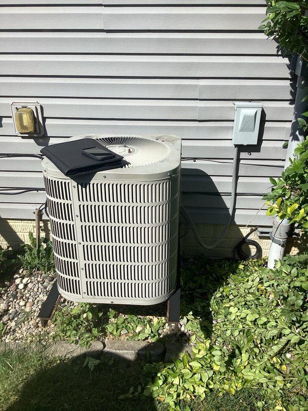 Completed comprehensive HVAC system evaluation for full equipment replacement. Assessed existing indoor furnace unit located in basement utility area and outdoor cylindrical condenser unit positioned on exterior concrete pad. Documented current system configuration including ductwork connections, electrical disconnect, and overall installation conditions to provide accurate replacement specifications and equipment recommendations.