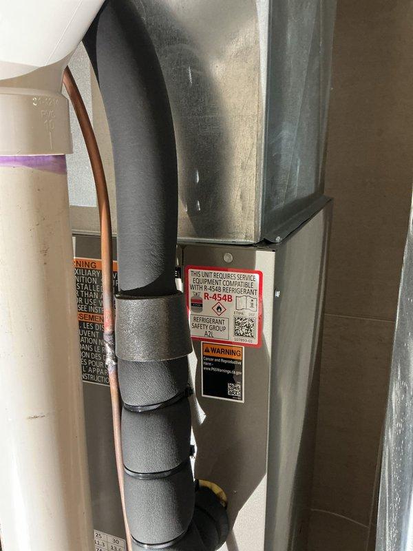 Responded to callback for new HVAC installation with customer reporting cool air escaping from multiple unsealed venting locations. Upon arrival, performed thorough inspection of ductwork system and air handler installation in mechanical room. Identified gaps in metal duct channels where green foam insulation strips were improperly seated, allowing conditioned air to bypass intended airflow paths. Verified refrigerant lines, PVC condensate drainage, and main air handler unit were properly installed per manufacturer specifications. Adjusted and properly secured foam insulation strips in vertical metal tracks adjacent to furnace unit to eliminate air leakage. Inspected all ductwork connections, supply and return plenums, and register boots throughout system for additional unsealed penetrations. Sealed identified gaps using appropriate methods to restore system efficiency and ensure proper airflow distribution. Verified system operation with no further air leakage detected at previously a