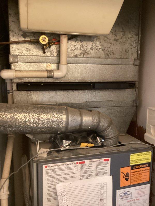 Conducted comprehensive assessment of existing HVAC system for furnace replacement. Evaluated current ductwork configuration, including galvanized sheet metal ducts and fittings with standard connection methods, and inspected mechanical utility area housing existing furnace unit. Documented equipment specifications, condensate drainage system with PVC piping, and overall installation environment to provide accurate replacement estimate including necessary modifications to existing duct connections and supporting infrastructure.