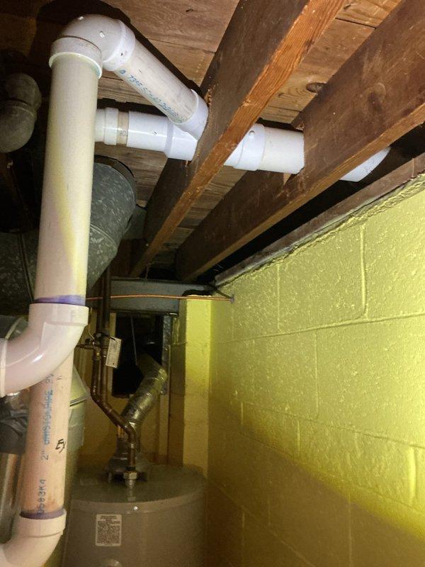 Responded to service call for furnace producing loud noise during startup, an ongoing issue with the 10-year-old unit. Upon arrival, performed comprehensive inspection of furnace system and associated components including ductwork, humidification system, and mechanical connections. Examined Aprilaire whole-home humidifier unit mounted to HVAC system, verifying proper integration with supply ductwork and checking all metallic connections and seam tape for secure installation. Inspected PVC condensate drainage piping with purple-primed joints to ensure proper drainage function and verify no blockages contributing to operational noise. Evaluated blower motor assembly, heat exchanger access points, and burner compartment for potential noise sources. Checked all ductwork connections, support brackets, and mounting hardware for loose components that could vibrate during operation. Assessed copper refrigerant lines and associated insulation for proper securing. Verified proper clearances arou