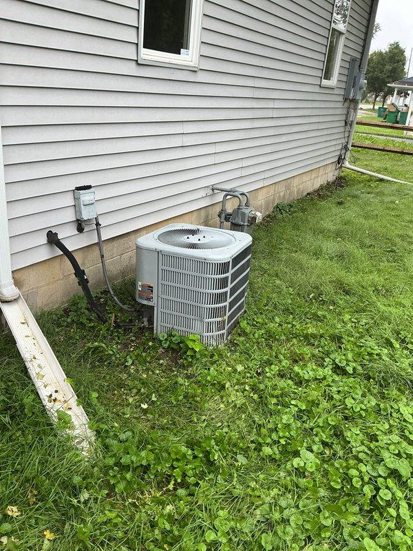 Responded to service call for water leakage from 22-year-old air conditioning system. Upon arrival, accessed property and performed diagnostic inspection of outdoor condensing unit and indoor air handler components. Inspected refrigerant lines, condensate drain system, and mechanical connections at both exterior unit location and basement installation area. Documented equipment condition showing age-related wear on piping and system components. Confirmed unit operation and identified source of water leakage for repair recommendations.