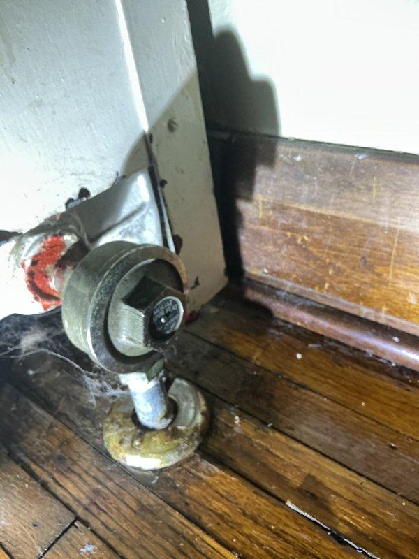 Responded to radiator leak complaint from previous winter season. Upon inspection, identified failed outlet valve as source of substantial water leakage. Documented condition of radiator outlet valve assembly and surrounding area showing evidence of significant water discharge and deterioration to adjacent surfaces and flooring.