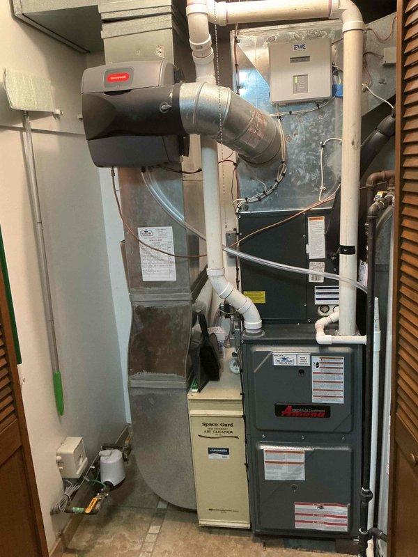 Completed comprehensive heating maintenance on 11-year-old natural gas furnace system. Performed combustion analysis using Testo 310 II flue gas analyzer, confirming optimal performance parameters with stack temperature reading 109.4°F, oxygen level at 6.5%, carbon monoxide at 11 ppm, ambient CO at 16 ppm, and combustion efficiency at 93.5%. System demonstrated proper fuel-to-air ratio with CO2 level at 8.14% and excess air at 40.1%, all within manufacturer specifications for safe and efficient operation. Inspected Amana furnace unit, Space-Gard air cleaner, and integrated Honeywell humidifier system. Verified proper operation of all components including heat exchanger, burner assembly, and venting system. Checked electrical connections, control wiring, and safety devices throughout installation. Confirmed adequate clearances and proper PVC condensate drainage. System operating safely and efficiently with no deficiencies noted.
