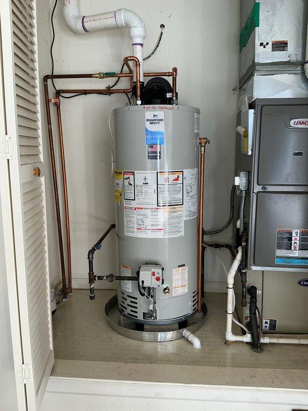 Installed 40-gallon Bradford White power vent water heater in residential utility closet with proper venting configuration. Ran 30 feet 3 inches of copper piping with appropriate connections, installed circulation pump, configured PVC condensate drain line, and placed unit on metal drip pan per code requirements. All plumbing connections, electrical wiring, and ventilation systems tested and verified operational upon completion.
