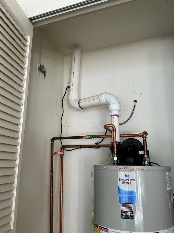 Installed 40-gallon Bradford White power vent water heater in residential utility closet with proper venting configuration. Ran 30 feet 3 inches of copper piping with appropriate connections, installed circulation pump, configured PVC condensate drain line, and placed unit on metal drip pan per code requirements. All plumbing connections, electrical wiring, and ventilation systems tested and verified operational upon completion.