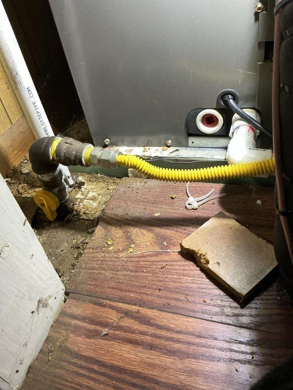 Responded to no heat call for gas-fired furnace of undetermined age. Upon inspection, identified corroded and heavily rusted heat exchanger component showing significant oxidation and deterioration, which posed both safety and operational concerns. The visible rust staining and compromised condition of the metallic housing indicated the unit had exceeded its serviceable lifespan and required immediate attention to restore safe heating operation.