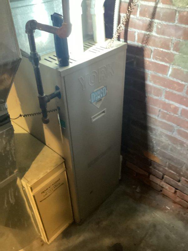 Completed furnace replacement estimate for existing York HVAC system located in basement mechanical room. Assessed current equipment configuration, ductwork connections, and installation requirements including gas line access, electrical connections, and venting system compatibility. Documented existing unit specifications and spatial constraints for proper sizing and replacement recommendations.