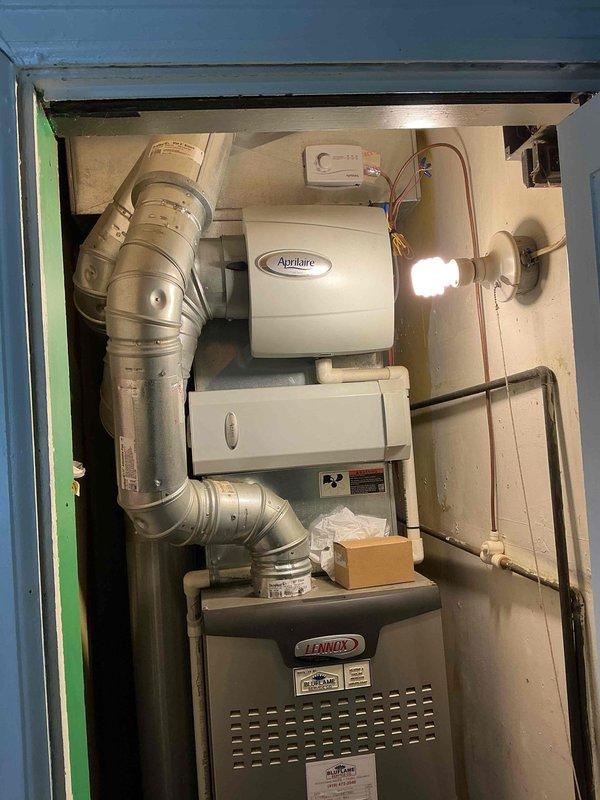 Performed scheduled maintenance on a 14-year-old Lennox gas furnace located in a utility closet. Completed standard tune-up procedures including inspection of burner assembly, heat exchanger, blower motor, and all safety controls. Verified proper operation of the Aprilaire humidifier integrated with the system. Checked gas connections and shutoff valves for leaks, inspected venting and ductwork connections, and tested condensate pump operation. All components found to be functioning within normal parameters and system operating safely.