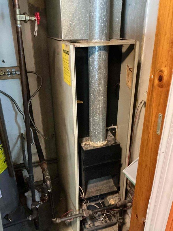 Responded to no-heat call on 44-year-old natural gas furnace. Upon arrival, performed diagnostic assessment of unit and confirmed furnace was not initiating heating cycle. Inspected burner assembly, heat exchanger access points, and ductwork connections in mechanical room. Documented equipment condition and configuration with photographs for service records.