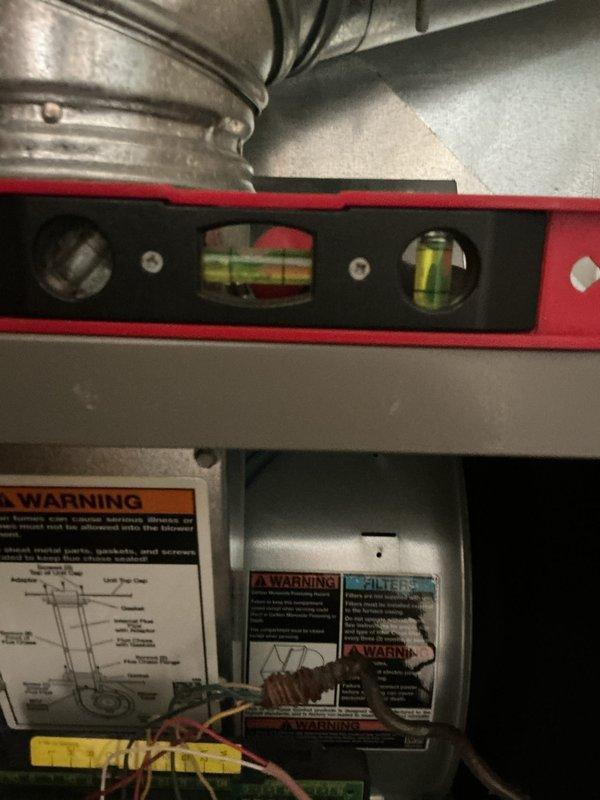 Completed preventive maintenance on 13-year-old furnace system in living room area. Performed comprehensive heating system inspection including temperature differential measurements, verified proper ductwork alignment and connections, checked electrical components and wiring connections, and confirmed all safety labels and warnings were intact. Unit is approaching recommended replacement age and customer was advised of renewal timeline.