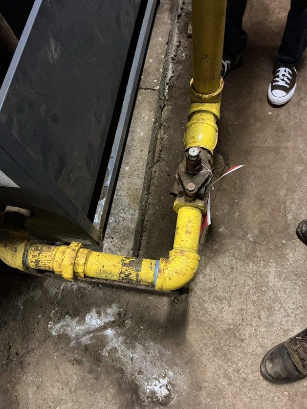 Responded to gas leak report at commercial property after utility company shut off gas supply due to suspected leak at boiler. Performed comprehensive visual inspection of gas piping system and boiler connections. Identified corroded and deteriorated components on boiler heat exchanger with significant rust accumulation and surface degradation. Inspected yellow gas piping runs showing wear and paint deterioration at multiple joints and valve assemblies. Conducted pressure testing on gas lines to isolate leak source and verify system integrity before restoration of service.