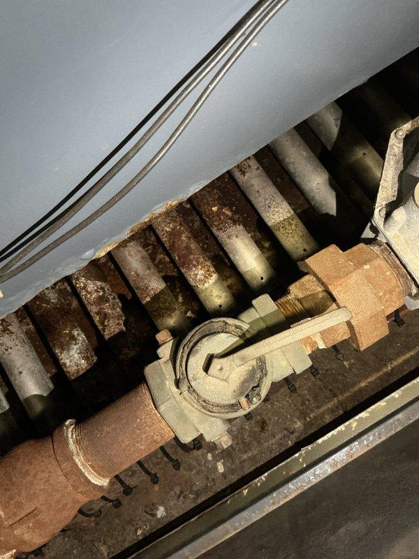 Responded to gas leak report at commercial property after utility company shut off gas supply due to suspected leak at boiler. Performed comprehensive visual inspection of gas piping system and boiler connections. Identified corroded and deteriorated components on boiler heat exchanger with significant rust accumulation and surface degradation. Inspected yellow gas piping runs showing wear and paint deterioration at multiple joints and valve assemblies. Conducted pressure testing on gas lines to isolate leak source and verify system integrity before restoration of service.
