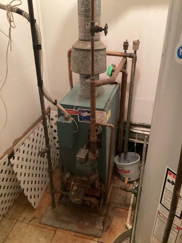 Completed comprehensive evaluation of existing heating system for boiler replacement estimate. Inspected aging boiler equipment, expansion tank, copper piping network, and associated hydronic heating components showing significant wear, corrosion, and oxidation throughout the system. Documented current installation conditions, measured equipment specifications, assessed venting requirements, and photographed existing setup to provide accurate replacement recommendations and specifications for new high-efficiency boiler system installation.