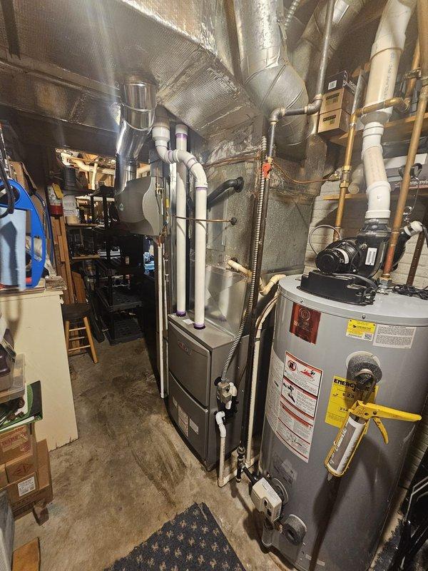 Completed installation of a 90% AFUE two-stage variable speed furnace in basement utility area. Replaced existing metal return drop to accommodate new equipment specifications. Installed 17-gallon whole-home humidifier integrated with the HVAC system. Established new gas line connections and electrical wiring to code specifications for safe furnace operation. Mounted and programmed new thermostat for two-stage heating control. Installed humidistat below main thermostat for independent humidity management. Connected white PVC exhaust and intake venting system, properly securing all condensate drainage lines. Verified all connections, tested system operation across both heating stages, and confirmed proper variable speed blower functionality. Equipment is operational and performing to manufacturer specifications.
