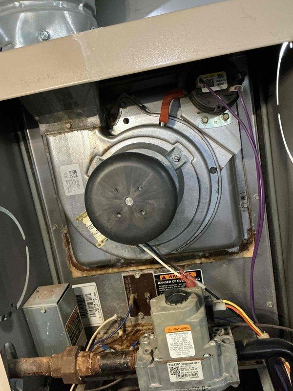 # HVAC Service Report - No Heat Call

Responded to no heat call for residential furnace that would not ignite or start. Upon inspection, found unit in operational condition with significant age-related deterioration evident throughout. Extensive rust and corrosion observed on metal components, copper piping connections, and mounting brackets indicating prolonged moisture exposure. Internal components including inducer motor assembly, gas valve, circuit boards, and blower motor showed heavy dust accumulation and discoloration consistent with extended service life.

Performed diagnostic testing and visual inspection of all major components including gas valve assembly, ignition system, inducer motor, blower assembly, and control boards. Verified proper electrical connections and wiring throughout unit. Examined condensate drainage system and associated piping. Despite customer report of non-operation, unit appeared functional during service visit, suggesting intermittent failure or issue