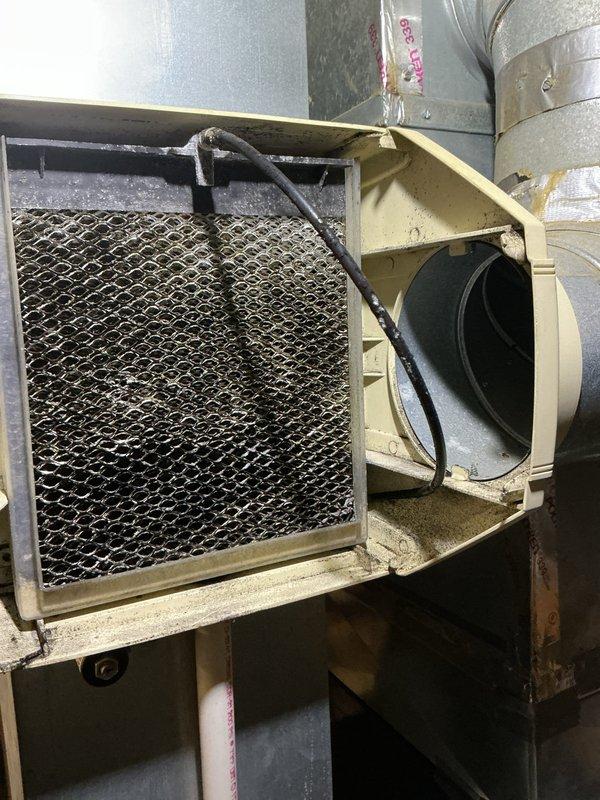 Completed standard air conditioning tune-up on approximately 8-year-old outdoor condensing unit. Performed comprehensive system inspection, accessed air handler unit to examine blower assembly and filter condition, documented accumulated debris on mesh filter indicating need for maintenance, and verified proper operation of all HVAC components including ductwork connections and electrical wiring.